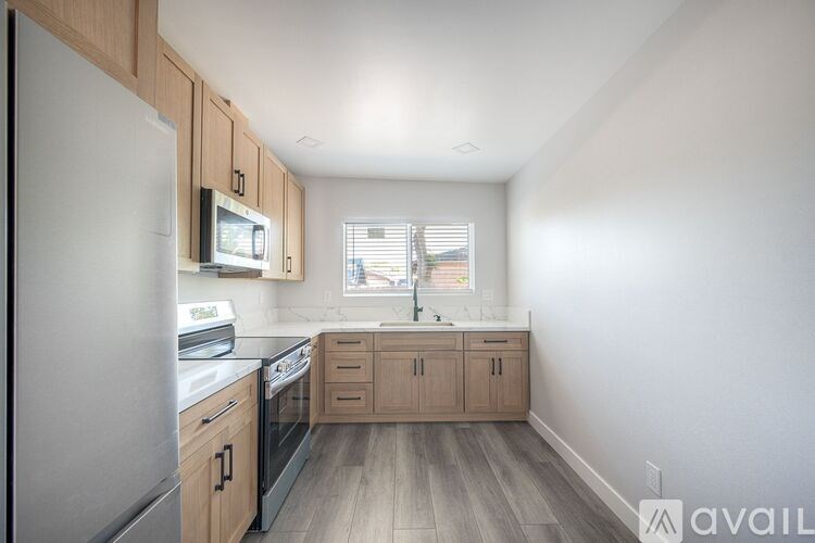 A kitchen with wooden cabinets and stainless steel appliances.