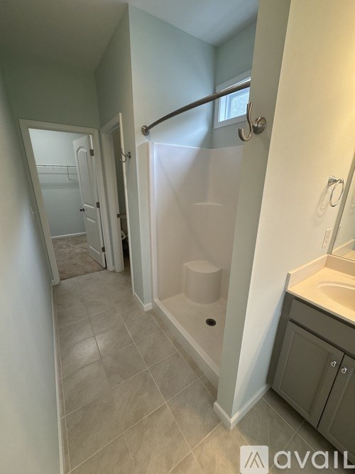 A bathroom with a walk-in shower and a toilet.