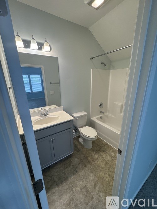 A bathroom with a sink, toilet, and bathtub.