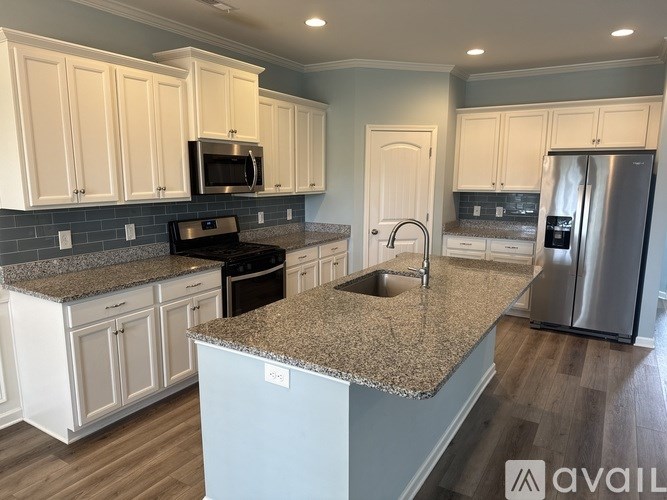 A kitchen with granite countertops and stainless steel appliances.
