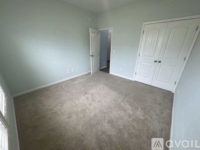 A room with a carpeted floor and white walls.