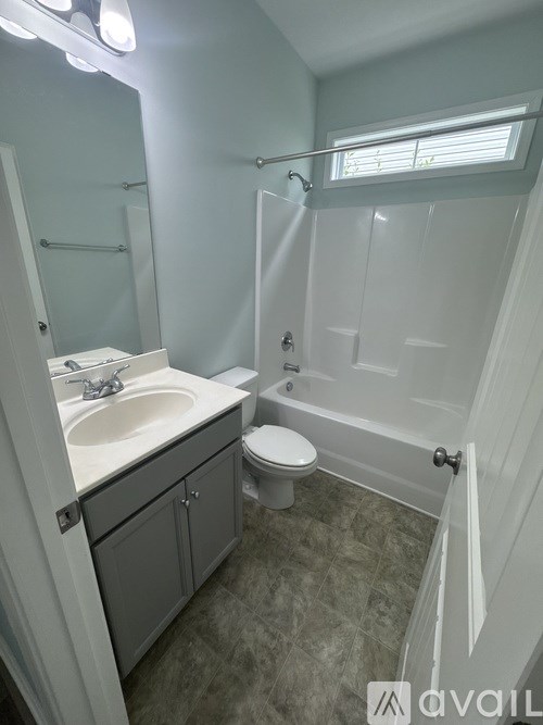 A bathroom with a sink, toilet, and bathtub.