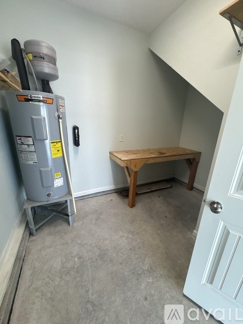 A room with a table and a fridge.