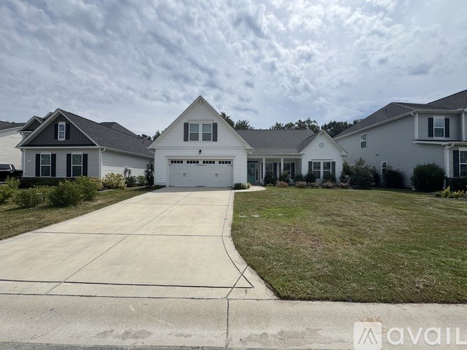 A house with a driveway in front of it is available for sale.