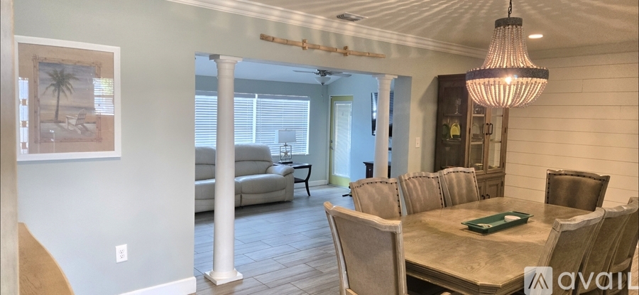 A living room with a white couch and a rug.