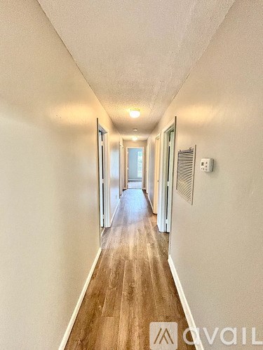A long hallway with a door at the end.