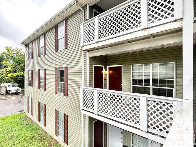 A two-story building with a balcony on the second floor.