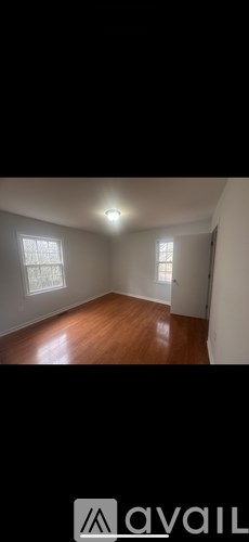 A room with wooden floors and white walls.