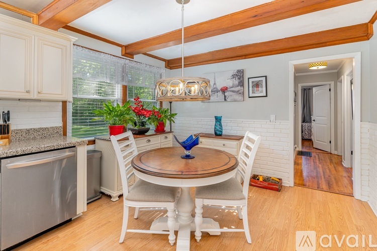 A kitchen with a table and chairs in the middle of the room.