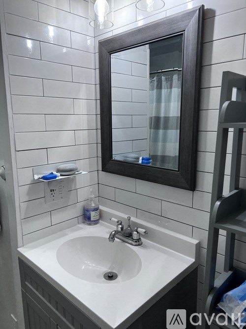 A bathroom sink with a mirror above it.