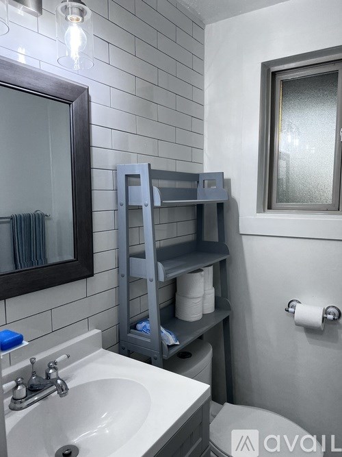 A bathroom with a white sink and a mirror above it.