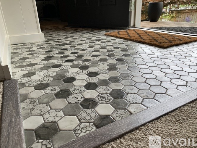 A black and white tiled floor with a wooden border.