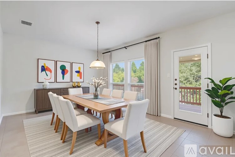 A dining room with a wooden table and chairs.