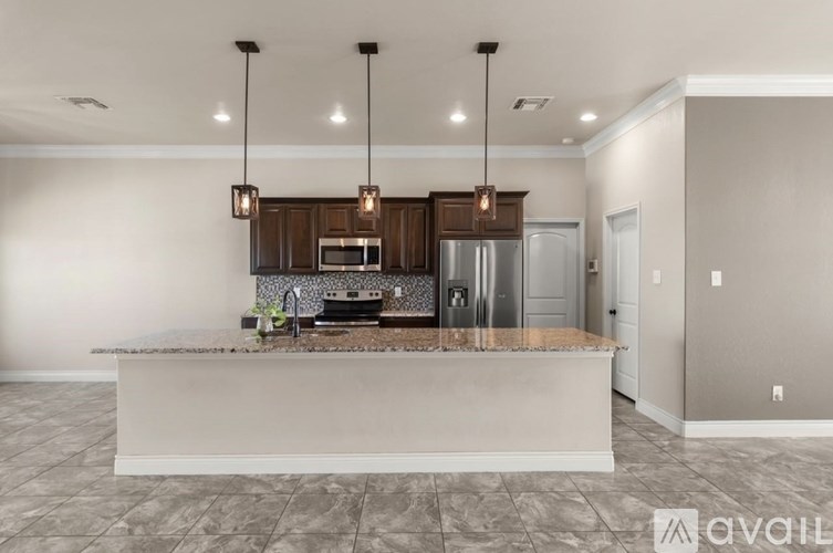 A kitchen with a countertop and cabinets is available for rent.