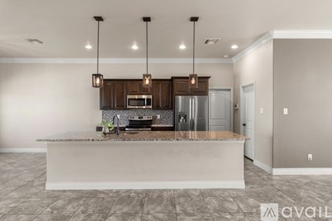 A kitchen with a countertop and cabinets is available for rent.