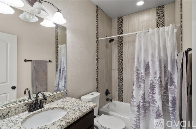 A bathroom with a sink, toilet, and shower.