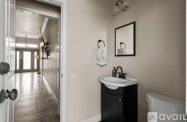 A bathroom with a sink, mirror, and bathtub.