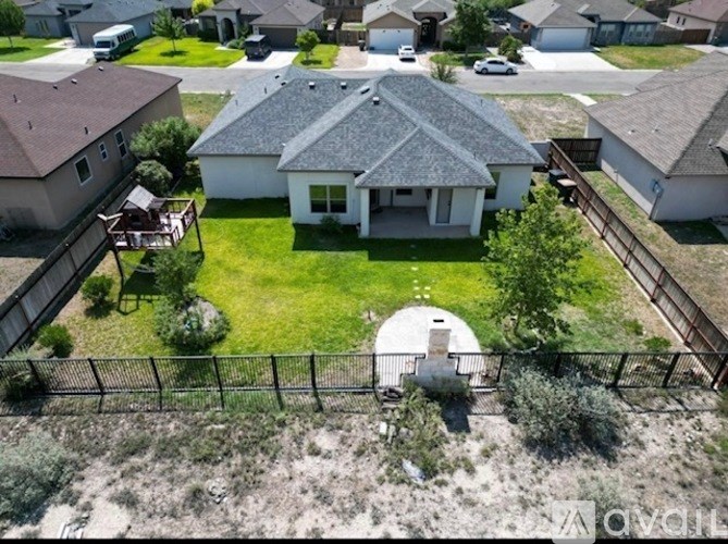 A house with a white roof and a fence in front of it.