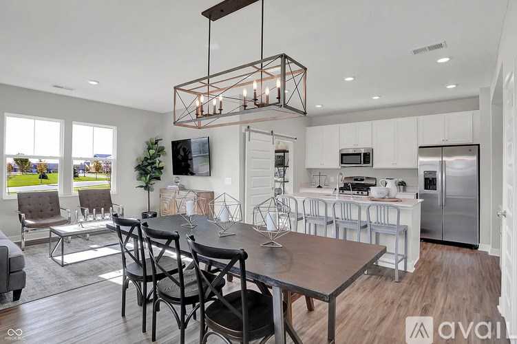 A modern kitchen with a dining table and chairs.