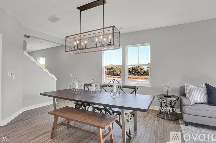A modern dining room with a wooden table and bench.