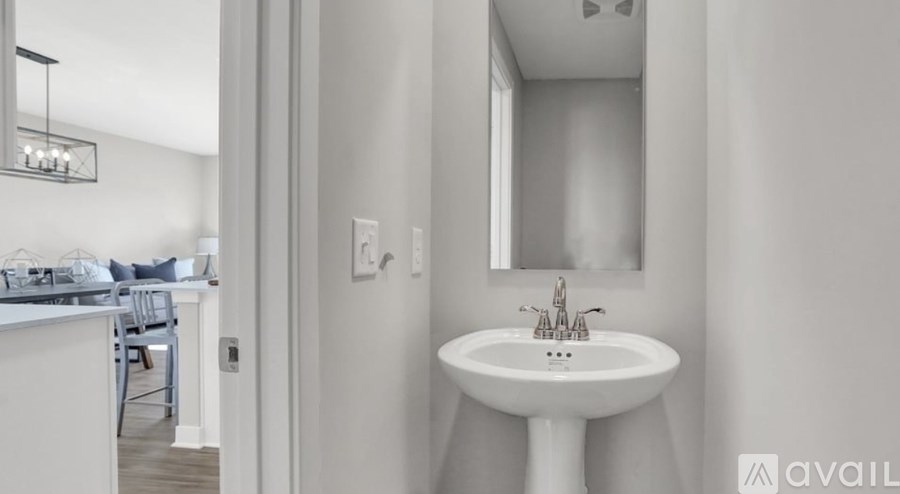 A white bathroom sink with a mirror above it.