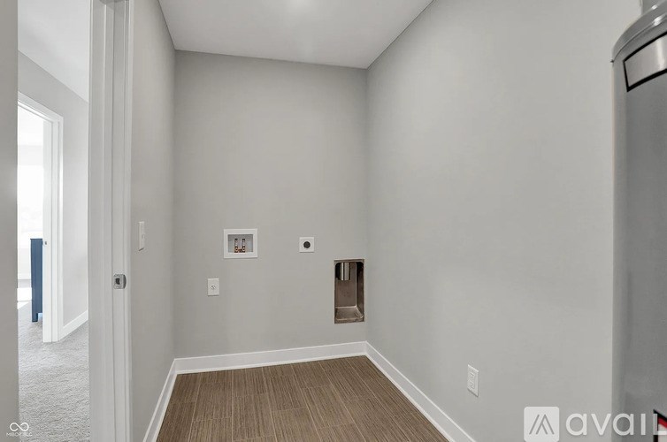 A kitchen with white cabinets and appliances.