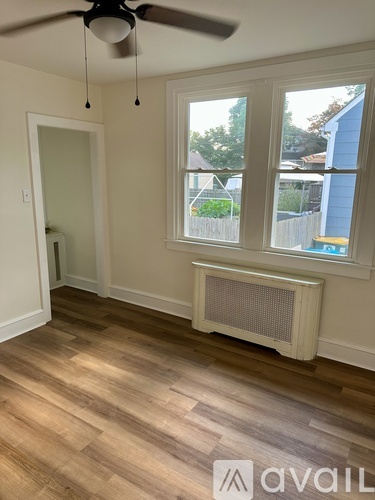 A room with a window and a fan.