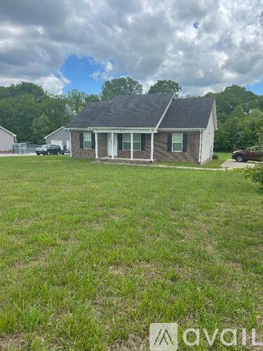 A house with a lawn in front of it.