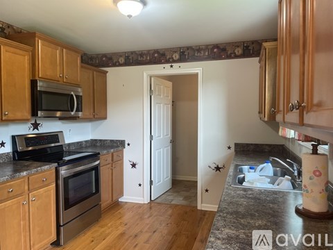 A kitchen with wooden cabinets and a white door.