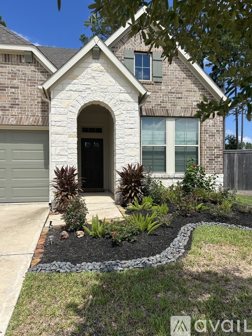 A house with a stone facade and a black door.