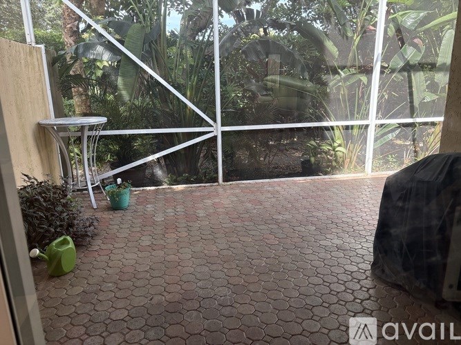 A patio with a table and chairs is visible through a glass door.