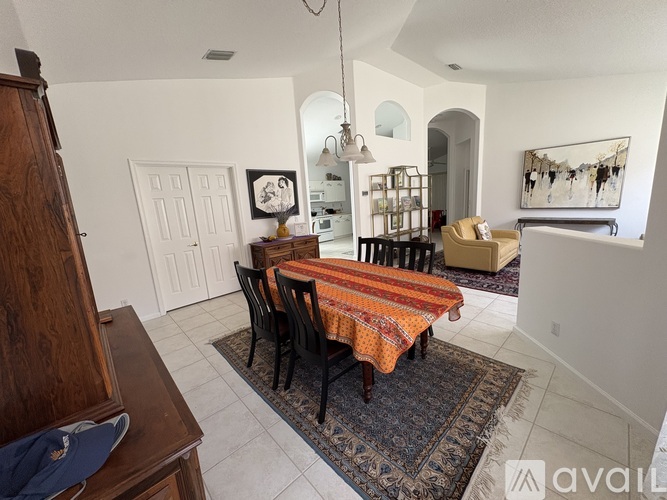 A dining room with a table set for four.