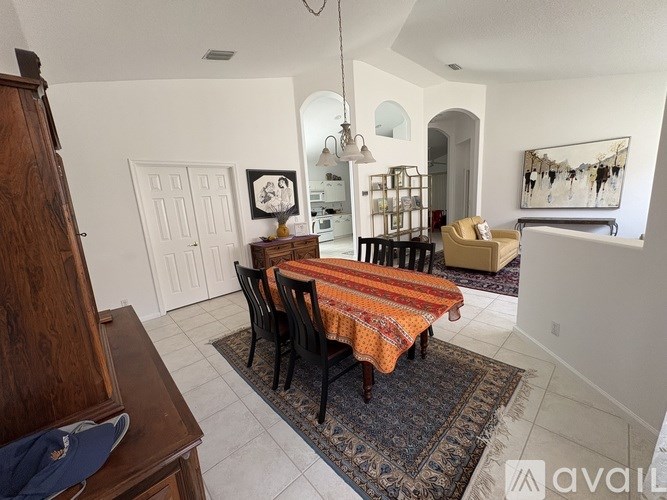 A dining room with a table set for four.