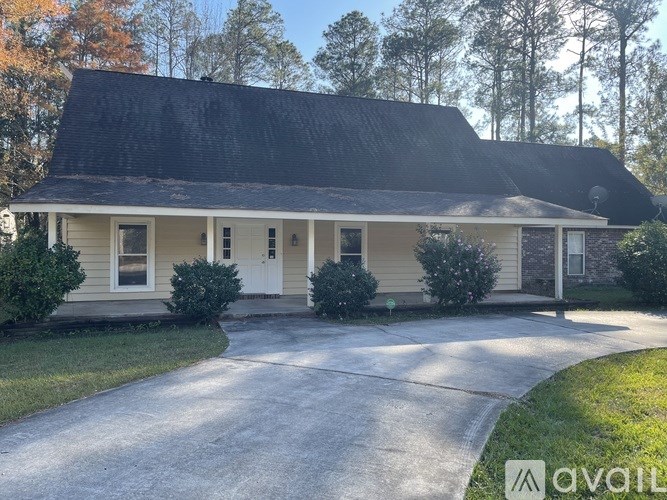 A house with a white door and a black roof.