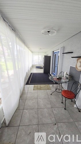 A room with a table and chairs in it.