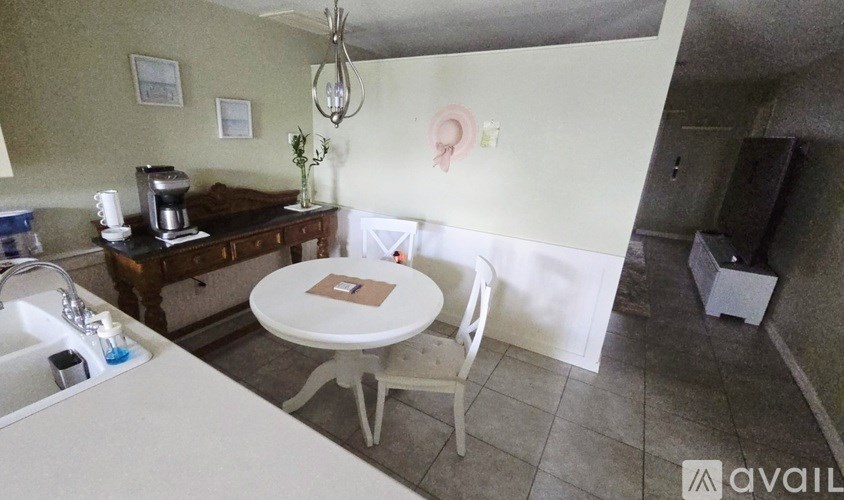 A kitchen with a table and chairs in the middle of the room.