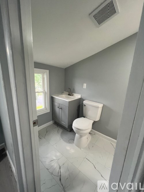 A bathroom with a toilet and sink.