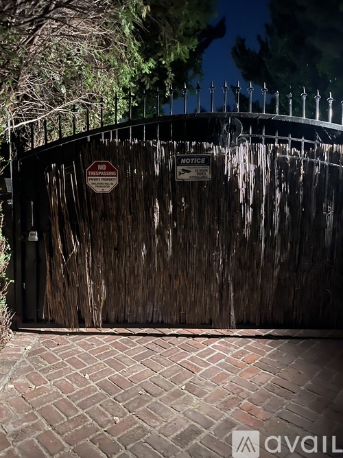 A gate with a sign that says "NO TRESPASSING" is closed.