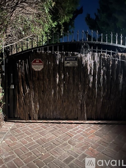 A gate with a sign that says "NO TRESPASSING" is closed.