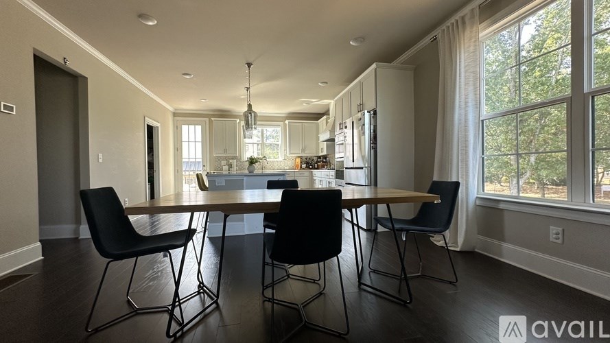 A dining room with a table and chairs.