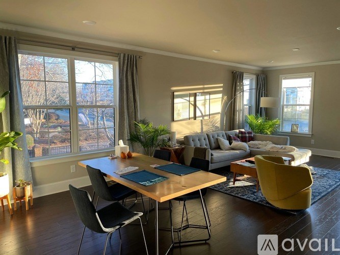 A modern living room with a large window overlooking a cityscape.