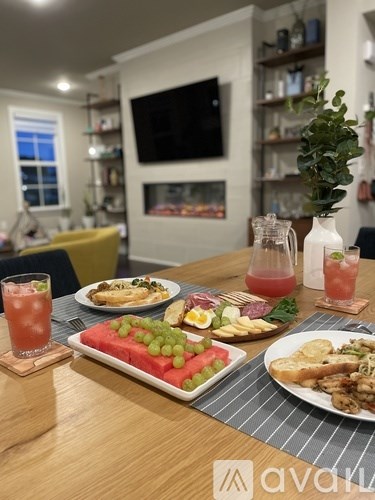 A table set with plates of food and drinks in a well-lit room.