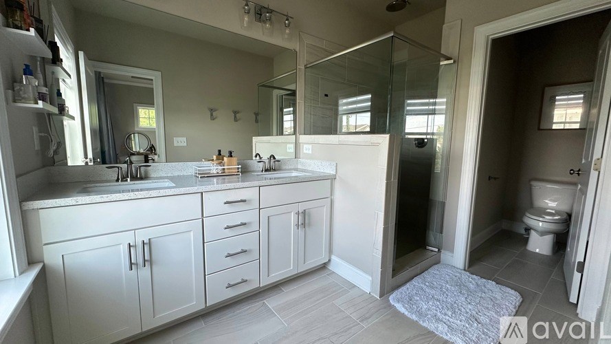 A bathroom with a sink, mirror, and toilet.