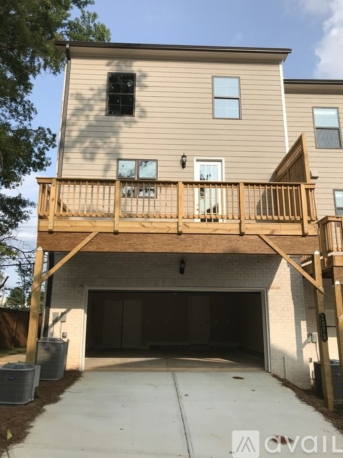A two-story house with a garage and a balcony.