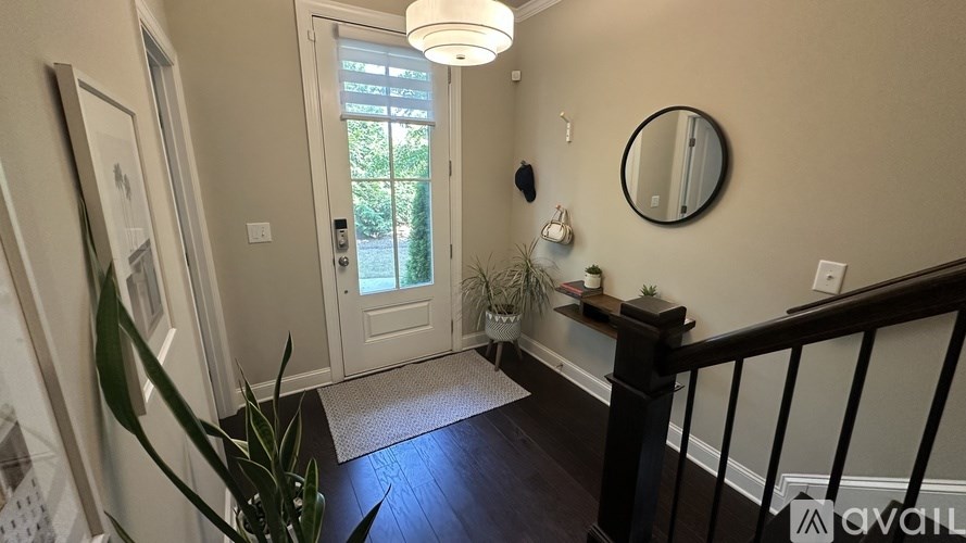 A hallway with a door leading to a balcony.