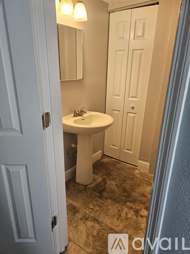 A bathroom with a sink and mirror.