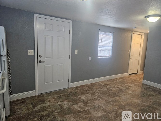 A room with a carpeted floor and a white door.
