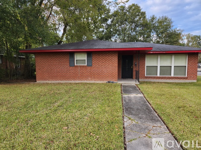 A red brick house with a black door and windows.