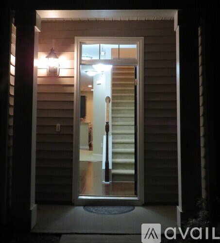 A white door with a glass window is open.