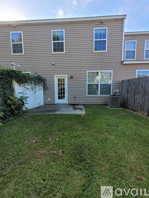 A house with a large lawn in front.